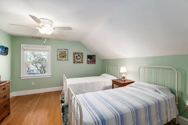 a bedroom with two large bed and a chandelier