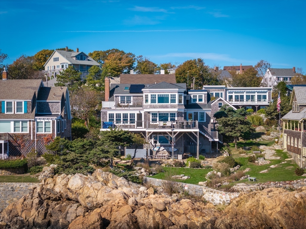 25 Salt Island Road Gloucester, MA 01930 - Photo 2 of 36 a front view of a house with a garden