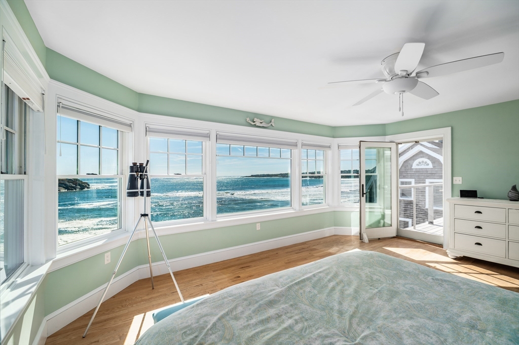 25 Salt Island Road Gloucester, MA 01930 - Photo 22 of 37 a spacious bedroom with a large bed and a large window