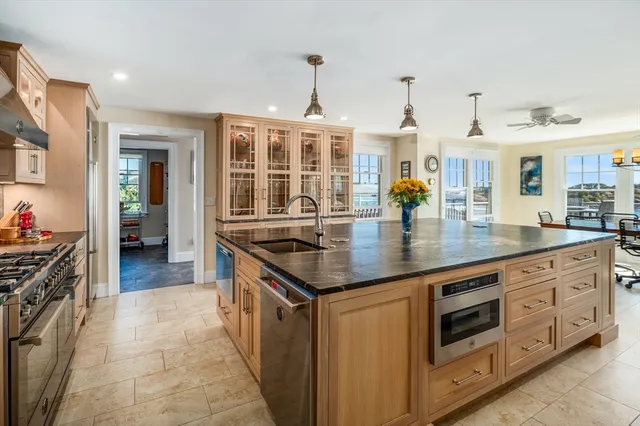 a kitchen with stainless steel appliances granite countertop a stove and more cabinets