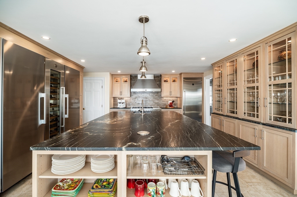 25 Salt Island Road Gloucester, MA 01930 - Photo 8 of 37 a view of a kitchen with kitchen island a counter top space and stainless steel appliances