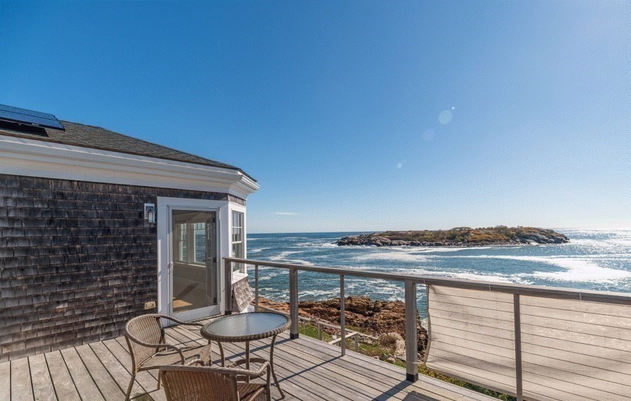 25 Salt Island Road Gloucester, MA 01930 - Photo 9 of 36 a view of a balcony with chair and table