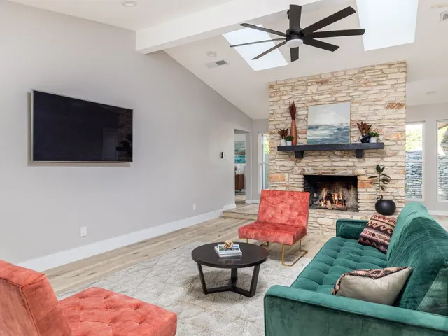 a kitchen with a sink a stove a refrigerator and white cabinets with wooden floor