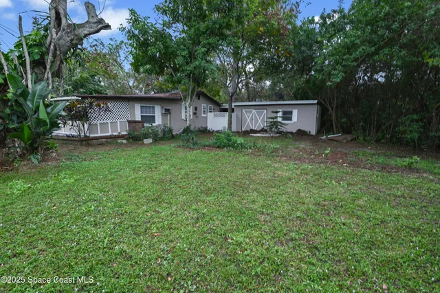 a view of a backyard with large trees
