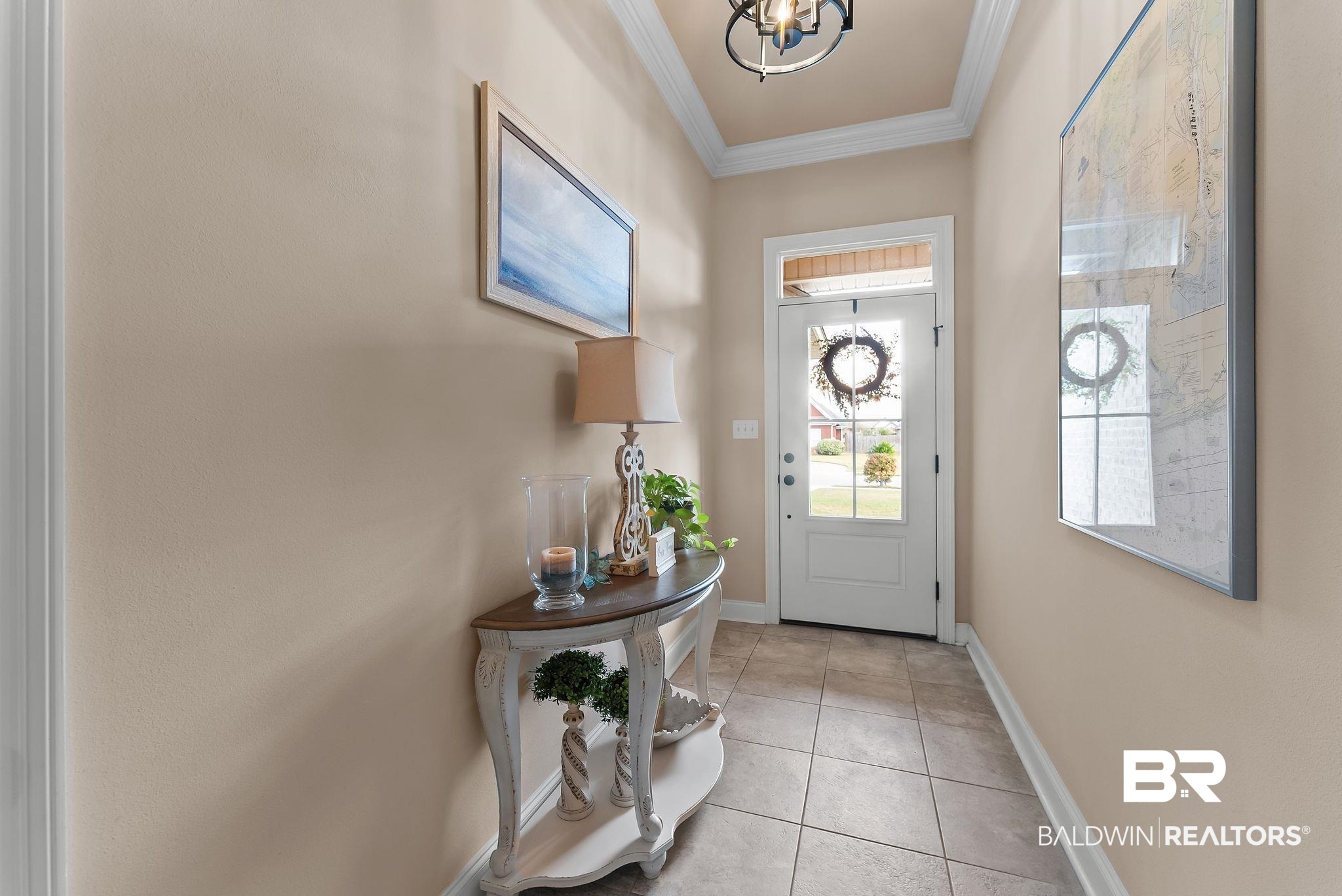 7015 Rocky Rd Loop Gulf Shores, AL 36542 - Photo 5 of 41 Doorway with tile patterned floors, ornamental molding, and hanging lights