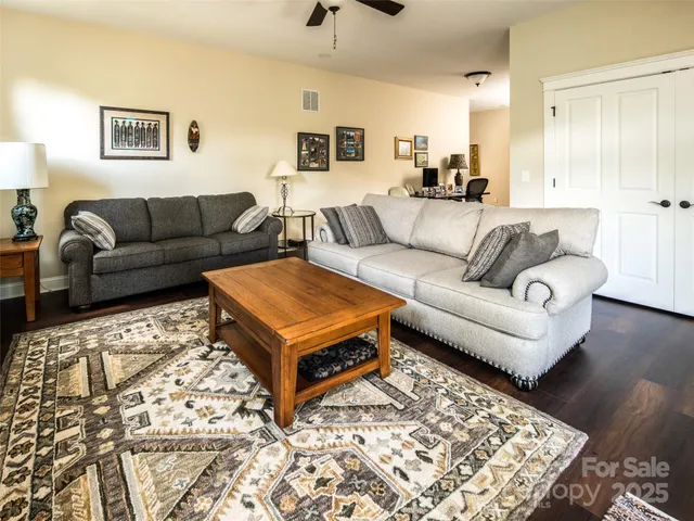 a living room with furniture and a rug