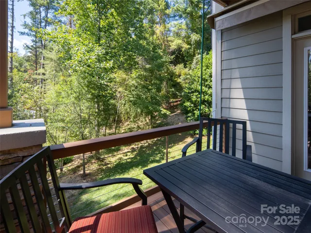 a view of a balcony with wooden floor and outdoor seating