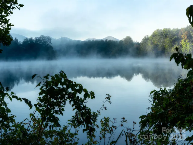 a view of a wooden deck and lake view