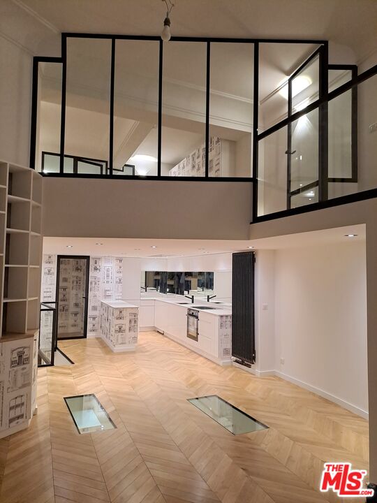 a kitchen with stainless steel appliances cabinets and a large window