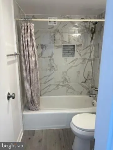 a bathroom with a shower and a toilet