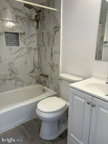 a bathroom with a toilet and a tub