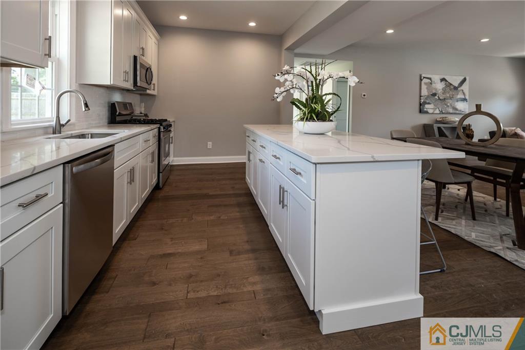 48 Brookville Road Edison, NJ 08817 - Photo 6 of 28 a kitchen with a sink stove and cabinets