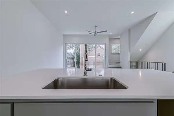 an empty room with a window and a ceiling fan