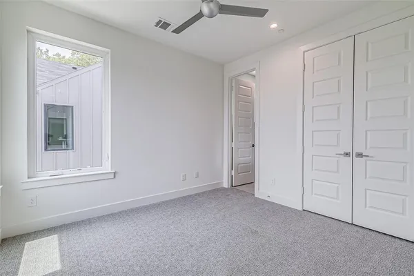 a spacious bathroom with a double vanity sink a mirror and a