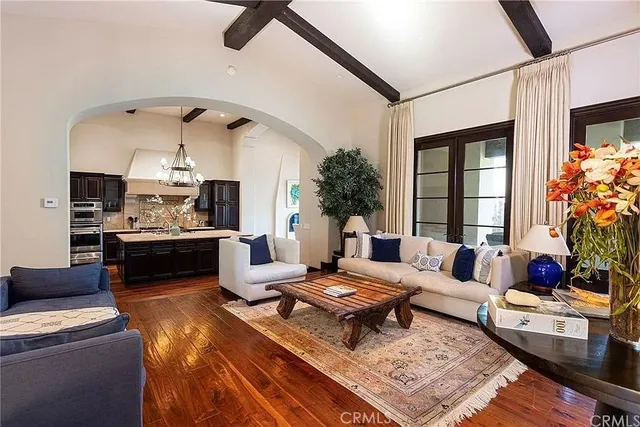a living room with furniture fireplace and a table