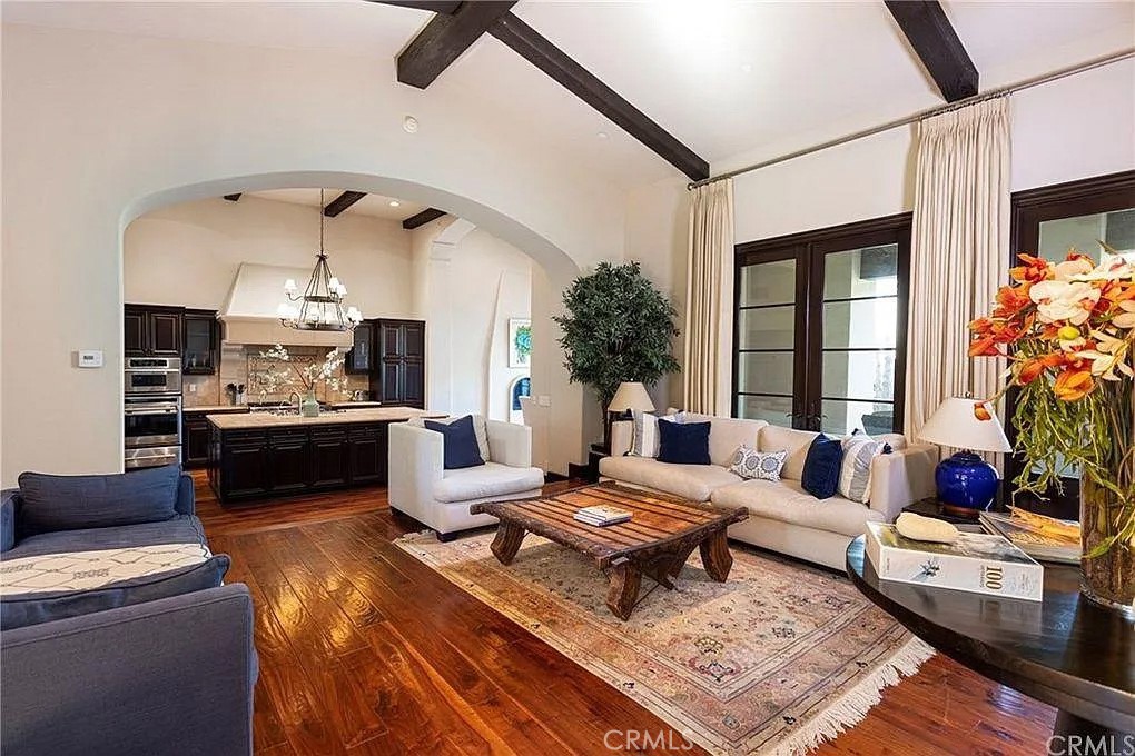 59 Vernal Spring Irvine, CA 92603 - Photo 11 of 33 a living room with furniture fireplace and a table