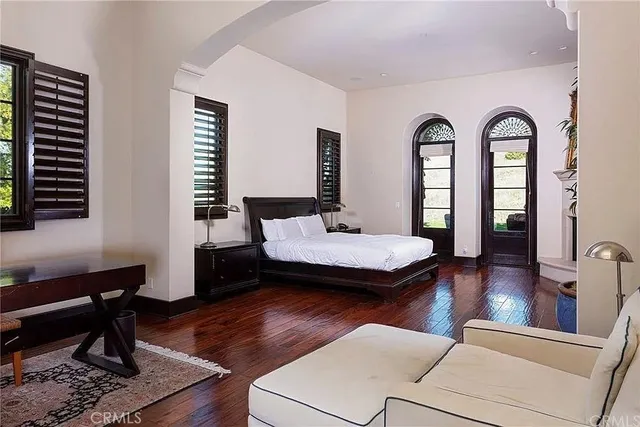 a living room with fireplace furniture and a large window