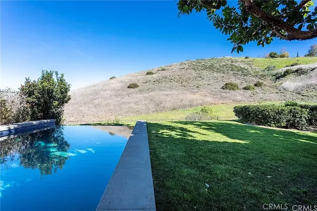 a view of a backyard with seating area and green space