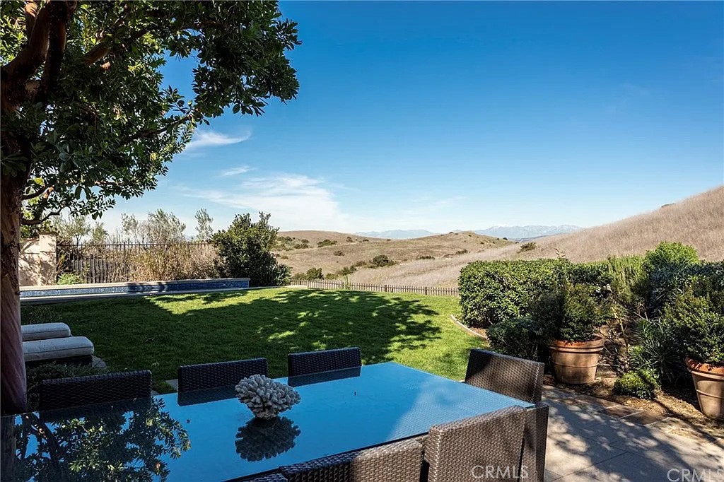 59 Vernal Spring Irvine, CA 92603 - Photo 21 of 33 a view of a backyard with seating area and green space