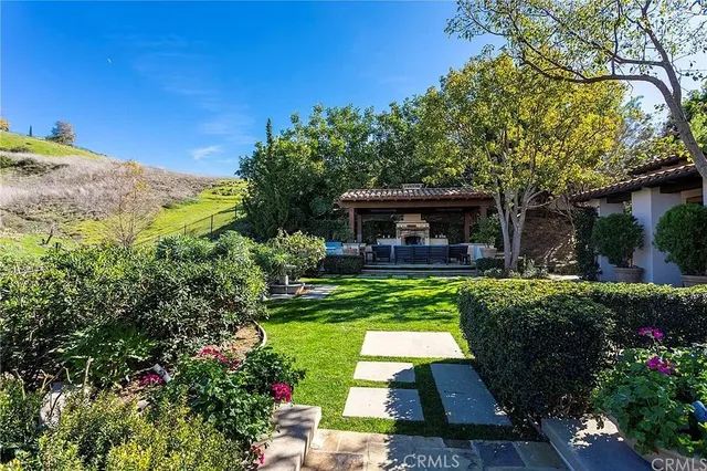 a view of house with a deck and furniture
