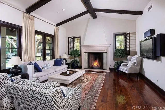 a living room with furniture fireplace and flat screen tv