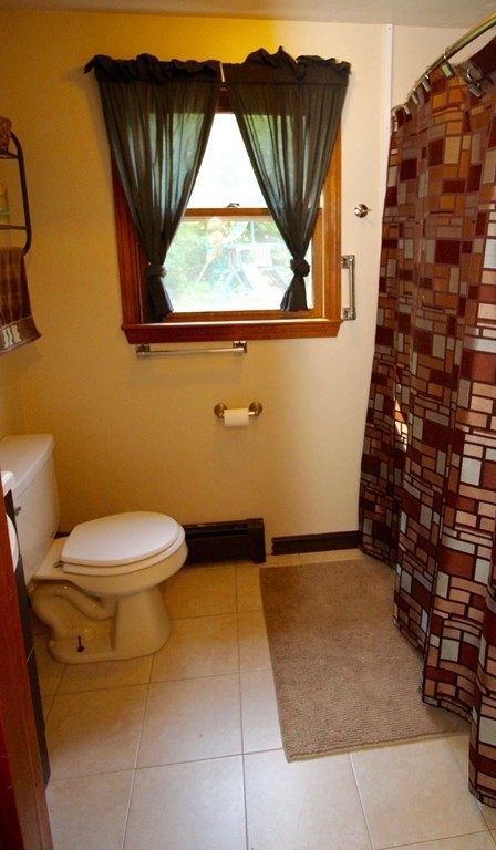106 Laurel View Road Templeton, MA 01468 - Photo 13 of 18 a bathroom with a toilet and a shower curtain