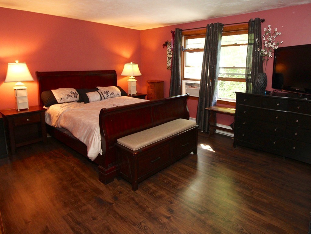 106 Laurel View Road Templeton, MA 01468 - Photo 8 of 18 a bedroom with a bed and wooden floor