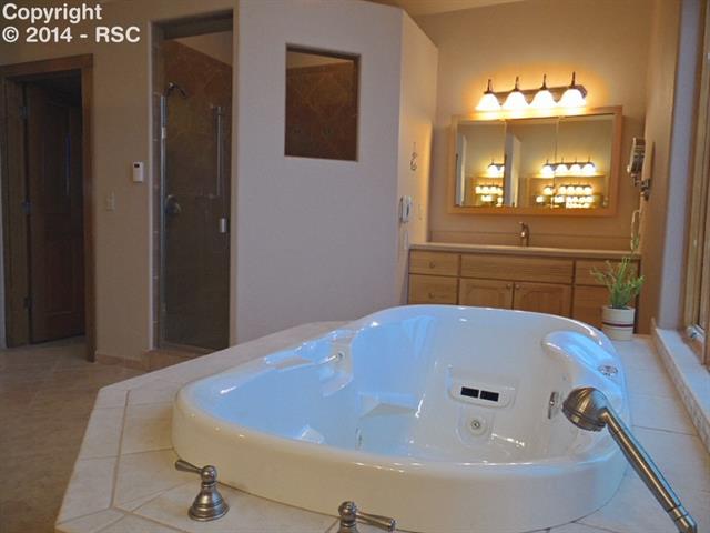 37285 Harrisville Road Calhan, CO 80808 - Photo 15 of 24 A Bath to "Spoil You" Jetted Tub ~ Multi-Head Shower ~ 2 Separate Vanities ~ Walk In Closet