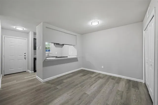 an empty room with wooden floor and closet