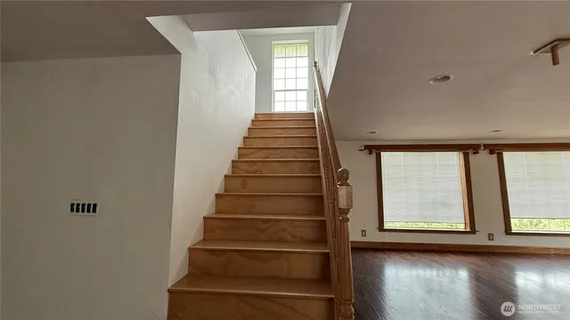 a view of entryway with wooden floor and windows
