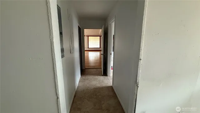 a view of a hallway with a wooden floor