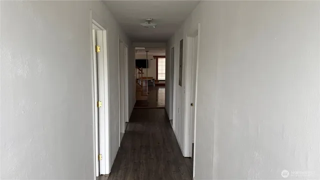 a view of a hallway with a wooden floor