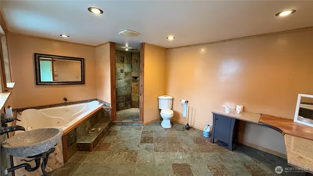 a spacious bathroom with a tub sink and toilet