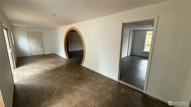 an empty room with windows and entrance