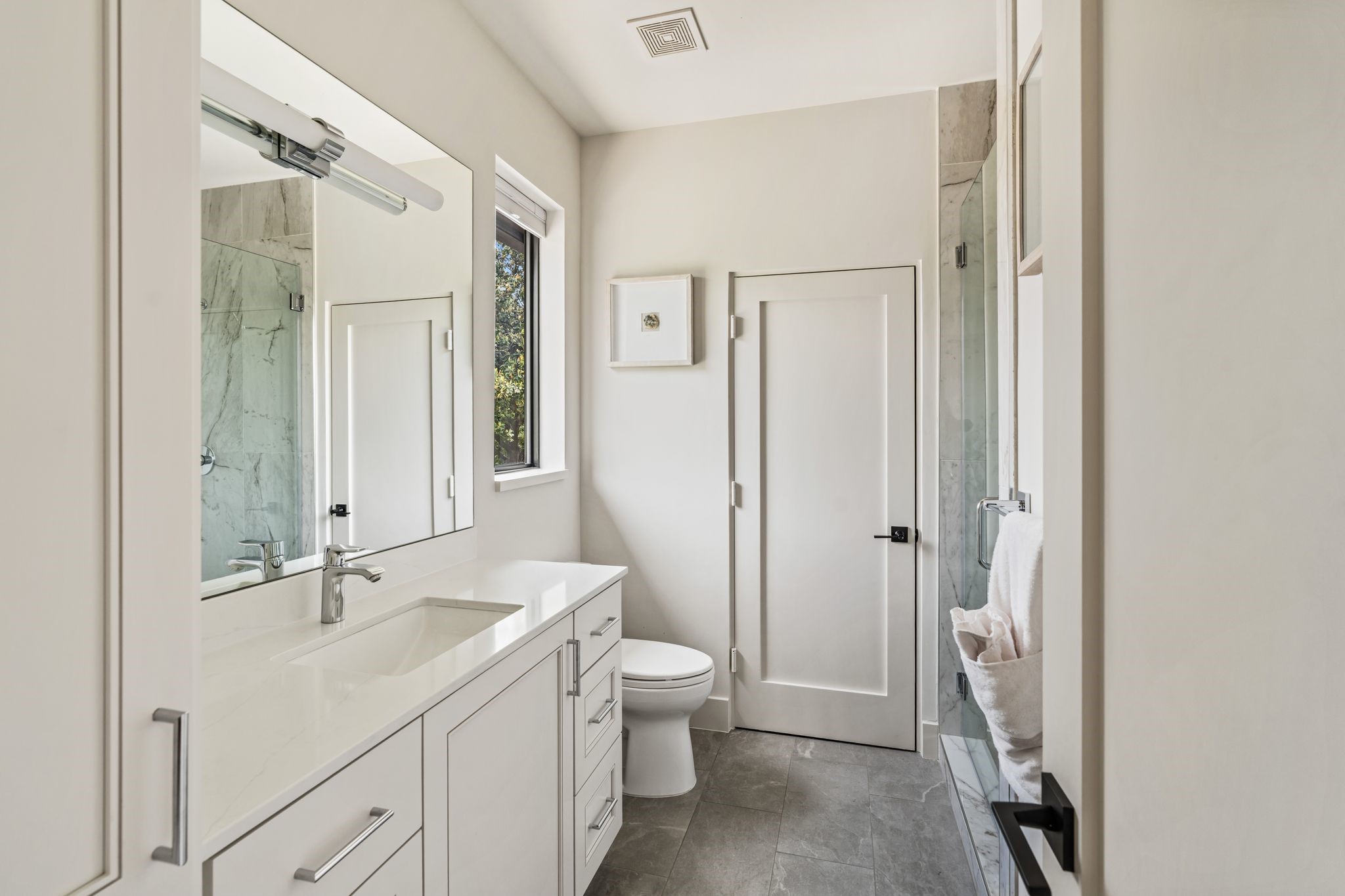 4638 Merwin Street Houston, TX 77027 - Photo 27 of 42 The ensuite bath features designer lighting and a spacious glass-enclosed walk-in shower.