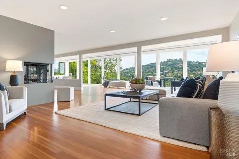a living room with furniture and large windows