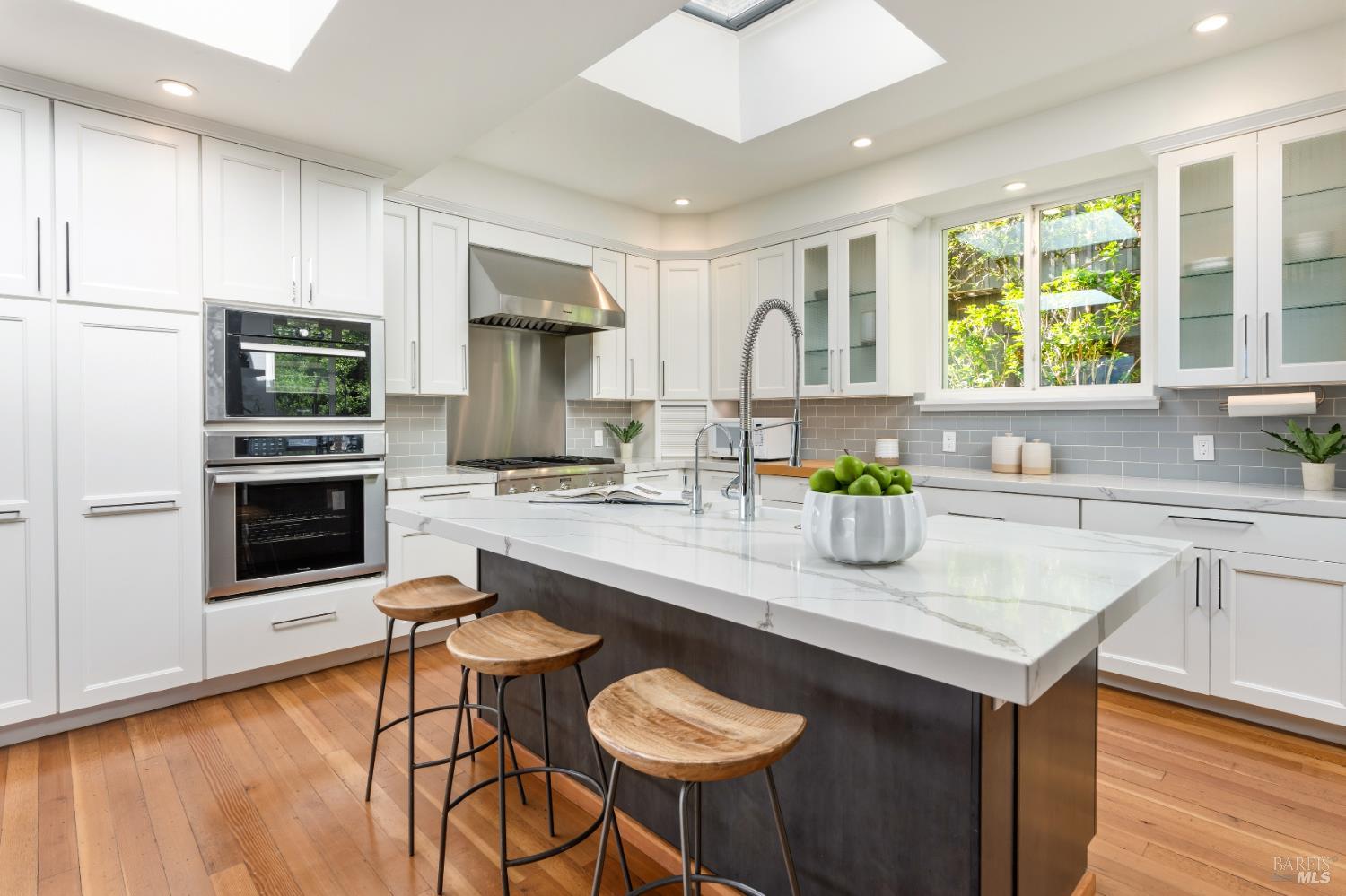 183 Reservoir Road San Rafael, CA 94901 - Photo 17 of 62 Stunning Chef's Kitchen is the perfect area for both Chef and guests --- a grand central island with sink and bar area makes a great place for family and friends to gather without being in the way. Premium Thermador appliances elevate the Kitchen along with a top of the line EuroCave wine refrigerator.