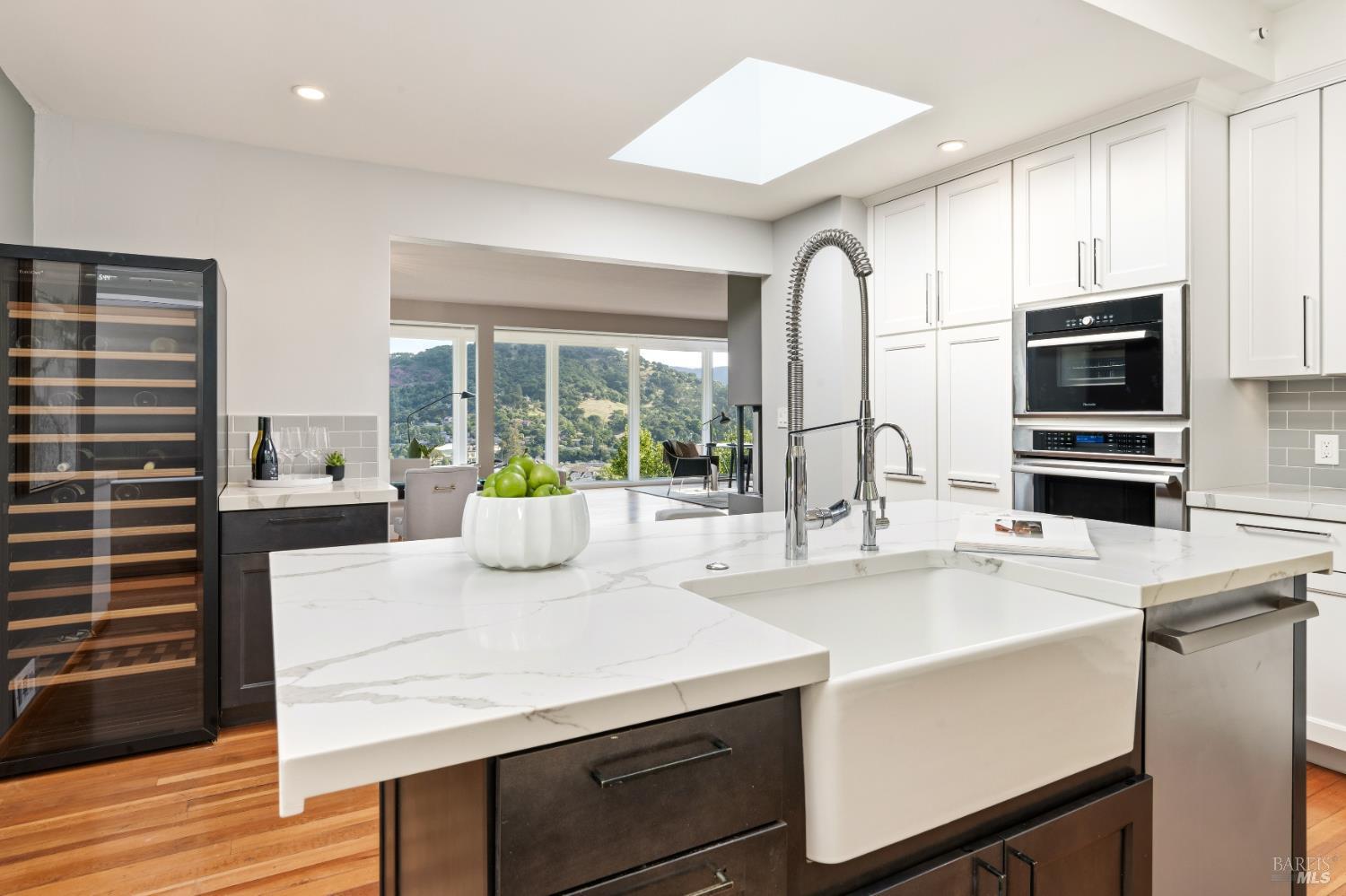 183 Reservoir Road San Rafael, CA 94901 - Photo 20 of 63 Even the Chef is not left out of the views! The EuroCave wine refrigerator and farmhouse sink add that feeling of luxury to this well appointed Kitchen.