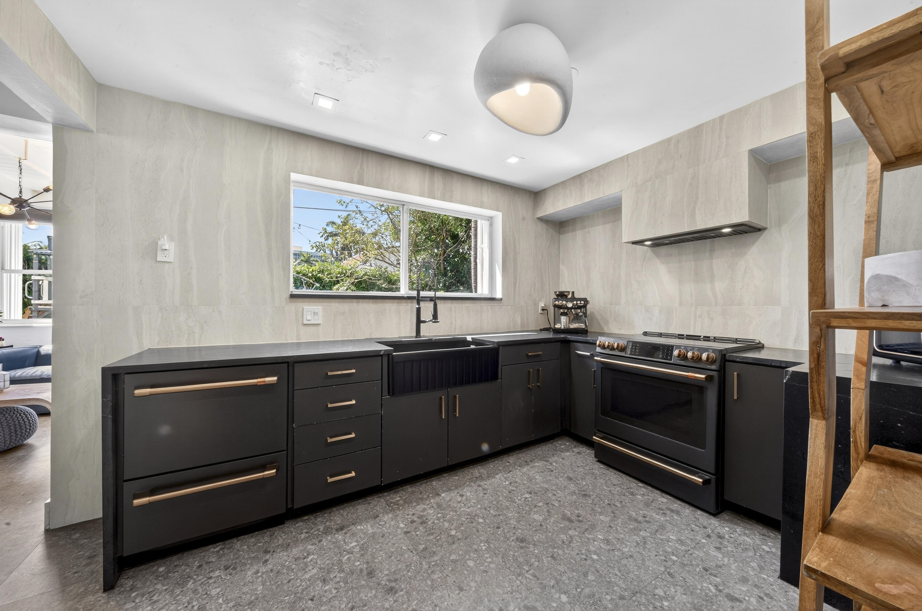 2630 Northeast 25th Street Lighthouse Point, FL 33064 - Photo 12 of 37 a kitchen with stainless steel appliances granite countertop a stove and a sink