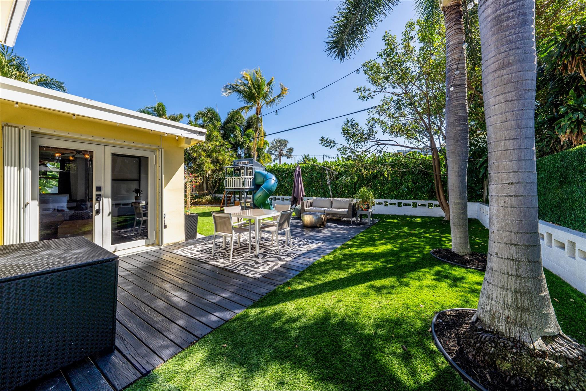 2630 Northeast 25th Street Lighthouse Point, FL 33064 - Photo 4 of 5 a view of a backyard with plants and patio