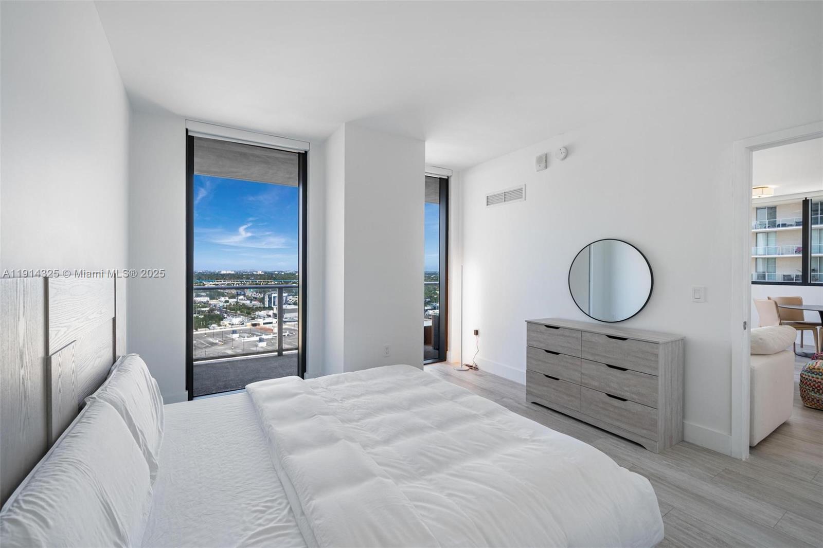 121 Northeast 34th Street, Unit 2109 Miami, FL 33137 - Photo 10 of 19 a bedroom with a bed and a dresser