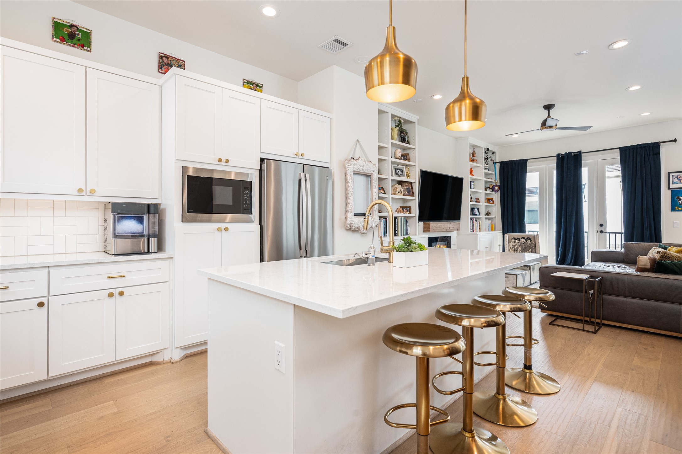 1747 Ojeman Spring Lane Houston, TX 77055 - Photo 8 of 22 a kitchen with stainless steel appliances kitchen island granite countertop a table chairs and a refrigerator