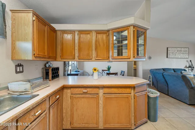 a kitchen with a sink cabinets and window
