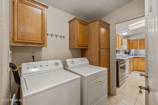a view of washer and dryer with kitchen view