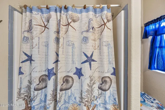 a view of bathroom with a shower curtain