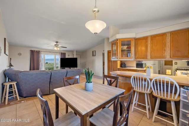 a view of a dining room with furniture and a window