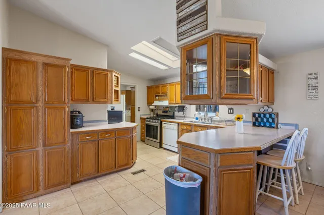 a kitchen with cabinets a sink and appliances