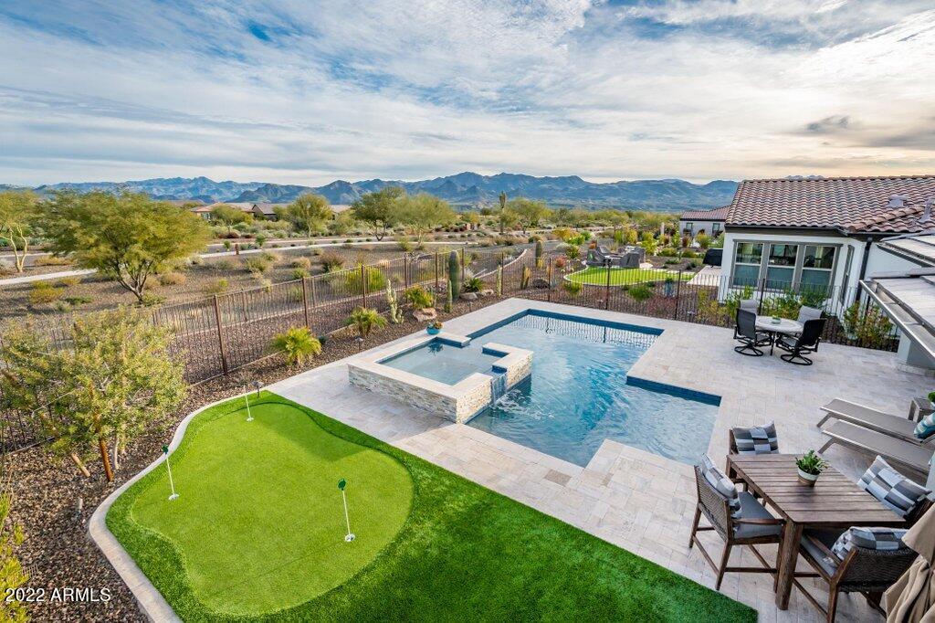 17860 East Cindercone Road Rio Verde, AZ 85263 - Photo 36 of 60 a view of a swimming pool with lounge chair