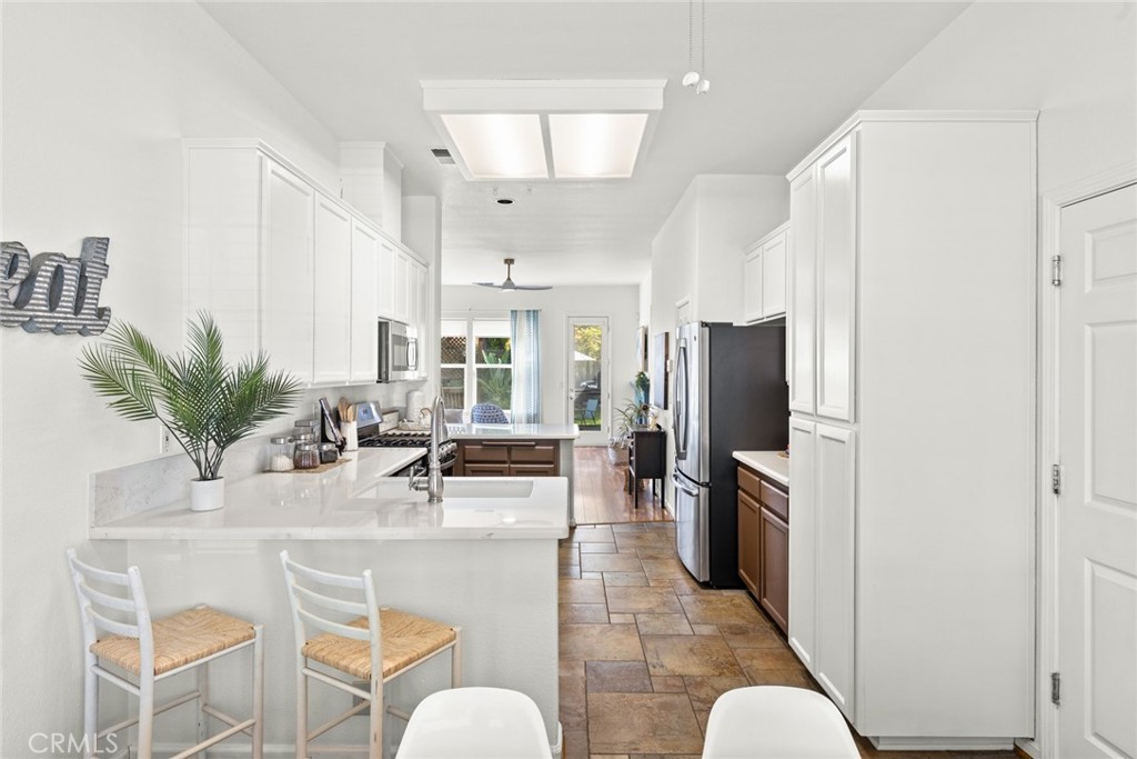 1517 Ridgebrook Way Chico, CA 95928 - Photo 11 of 28 a kitchen with stainless steel appliances kitchen island granite countertop a refrigerator and a dining table