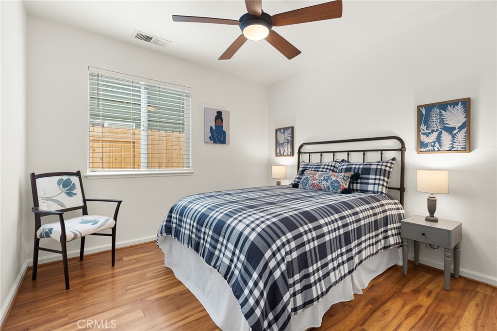 1517 Ridgebrook Way Chico, CA 95928 - Photo 16 of 28 a bedroom with a bed a chair and potted plants on the dresser